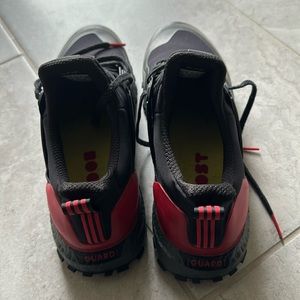 A fairly used Adidas ultra boost sneakers, black & red color in US size 11.5.